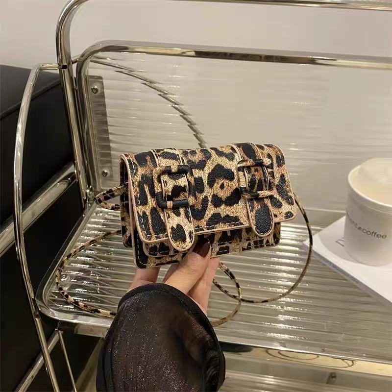 Fia leopard mini satchel, close-up of flap and patterned exterior