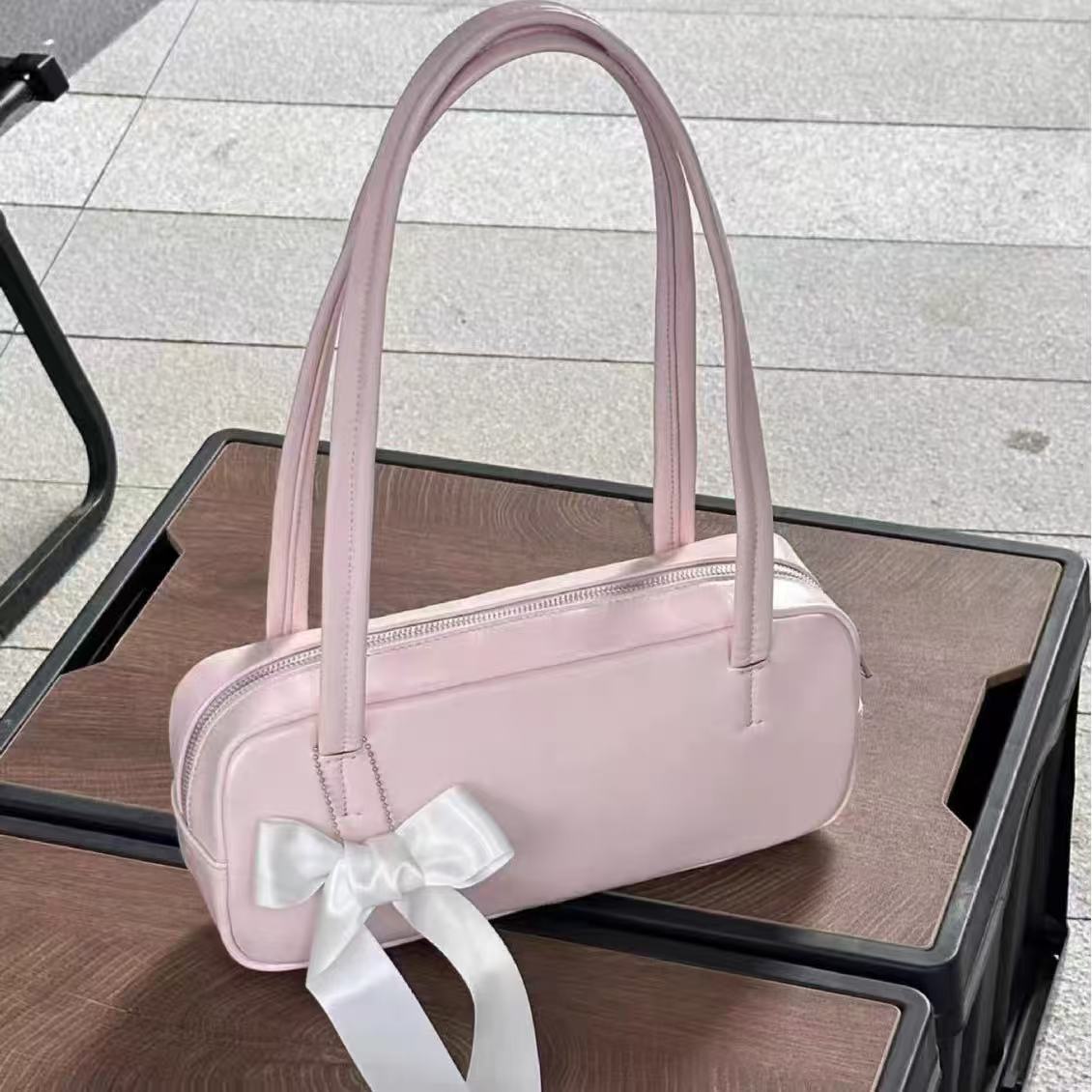 Amoirelle Rosalie blush pink shoulder bag with a white ribbon bow