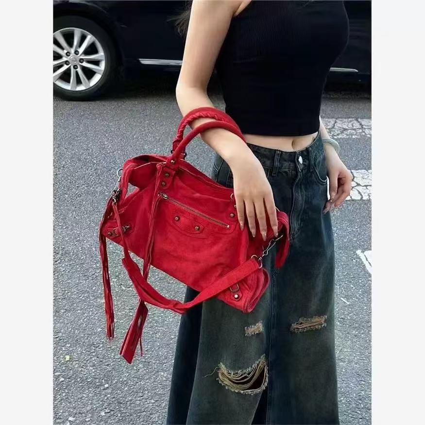 Amoirelle Roxie red moto satchel carried by its top handles