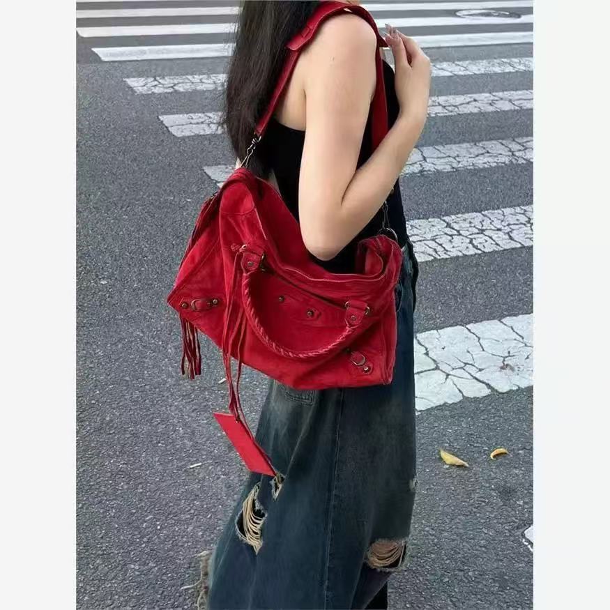 Roxie red moto bag worn on the shoulder