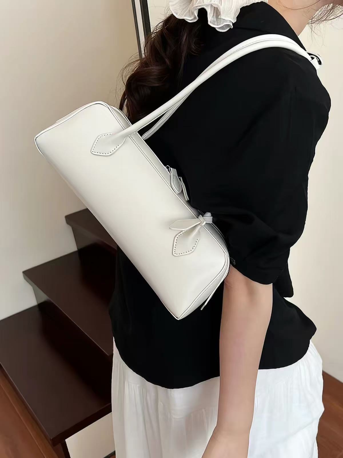 Solenne ivory shoulder bag, on-body styling view